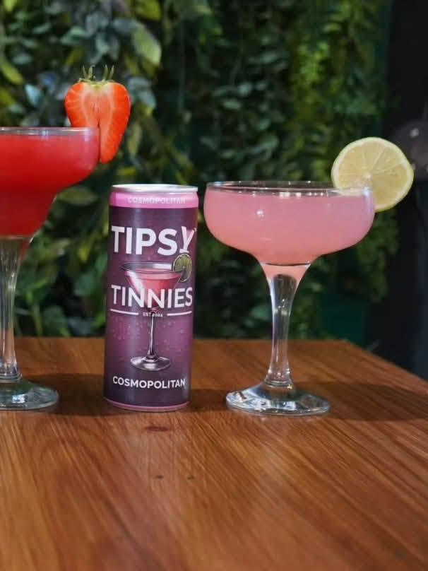 Cosmopolitan tin and a pink coupe with a lime wheel