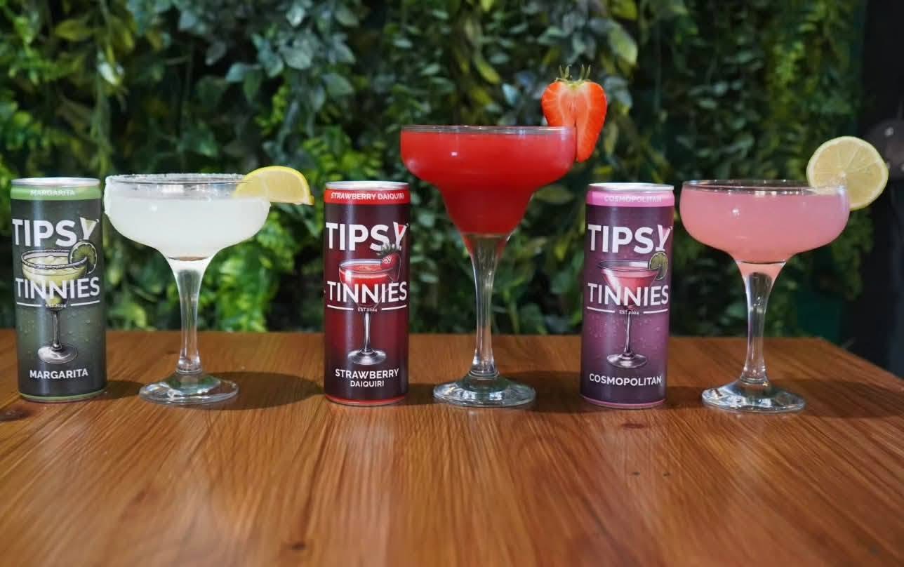 Margarita, Strawberry Daiquiri and Cosmopolitan poured into coupes beside their tins
