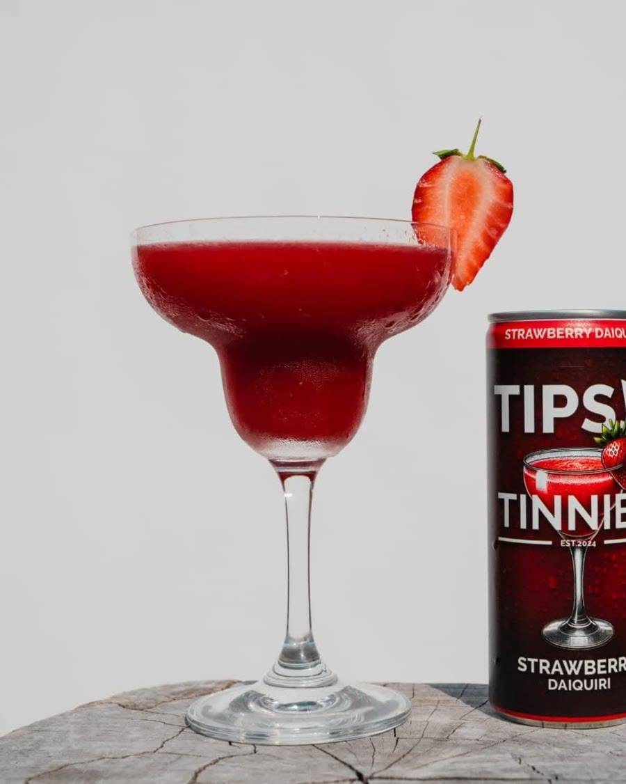 Strawberry Daiquiri in a margarita glass with a strawberry on the rim
